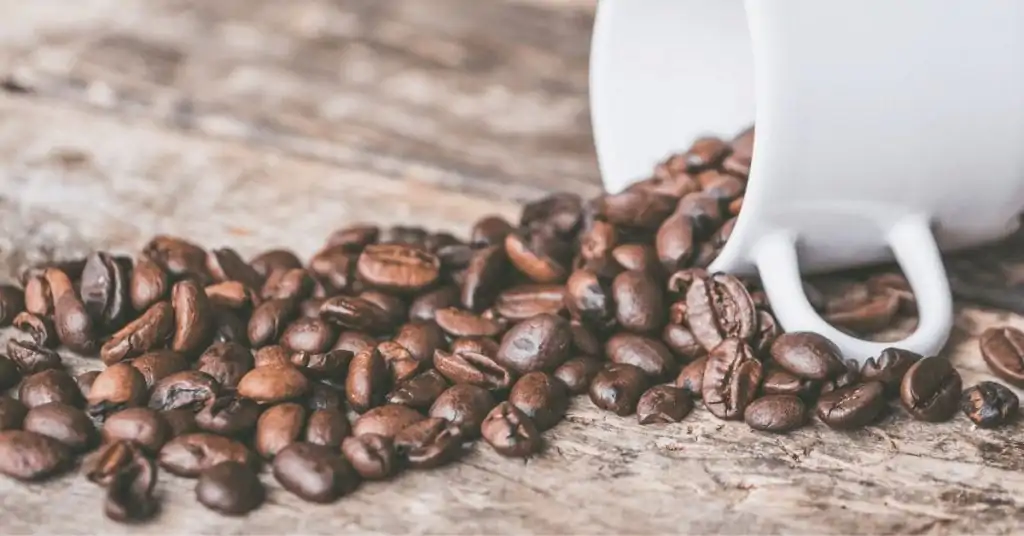 coffee beans spilling out of cup