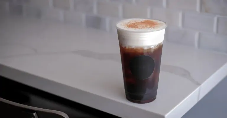 iced coffee with cold foam in a plastic cup