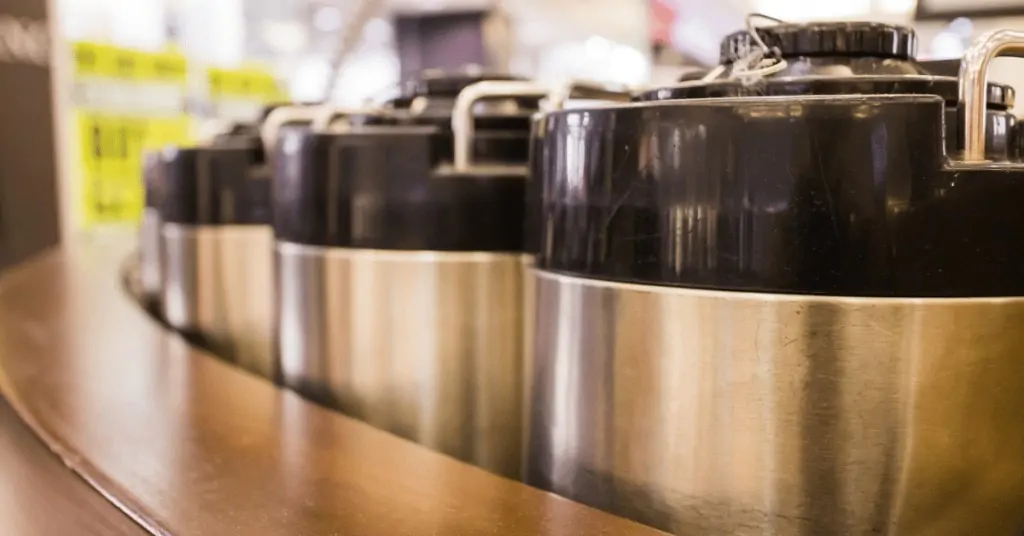 several coffee urns next to each other