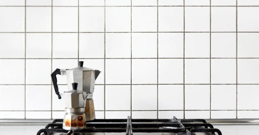 two moka pots on a stovetop