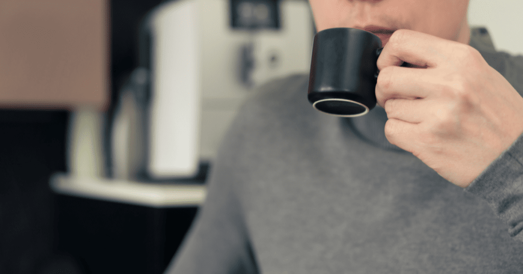 man drinking espresso