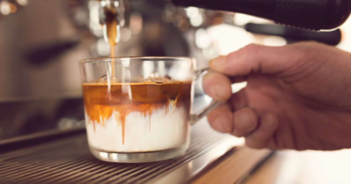 a person preparing iced macchiato coffee