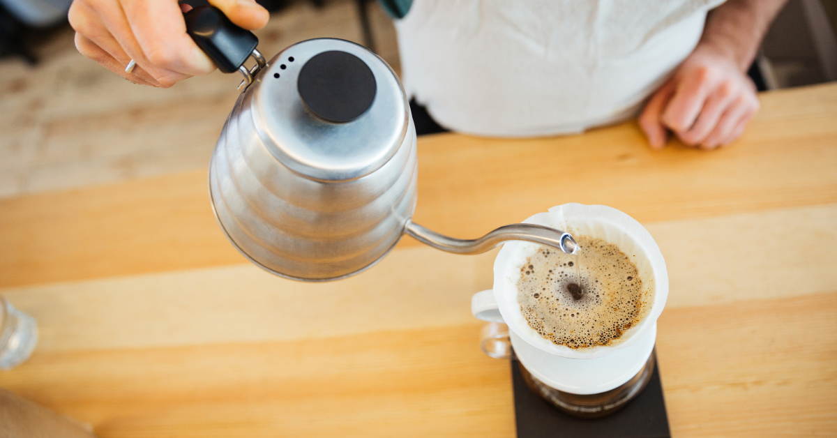 barista pouring hot water