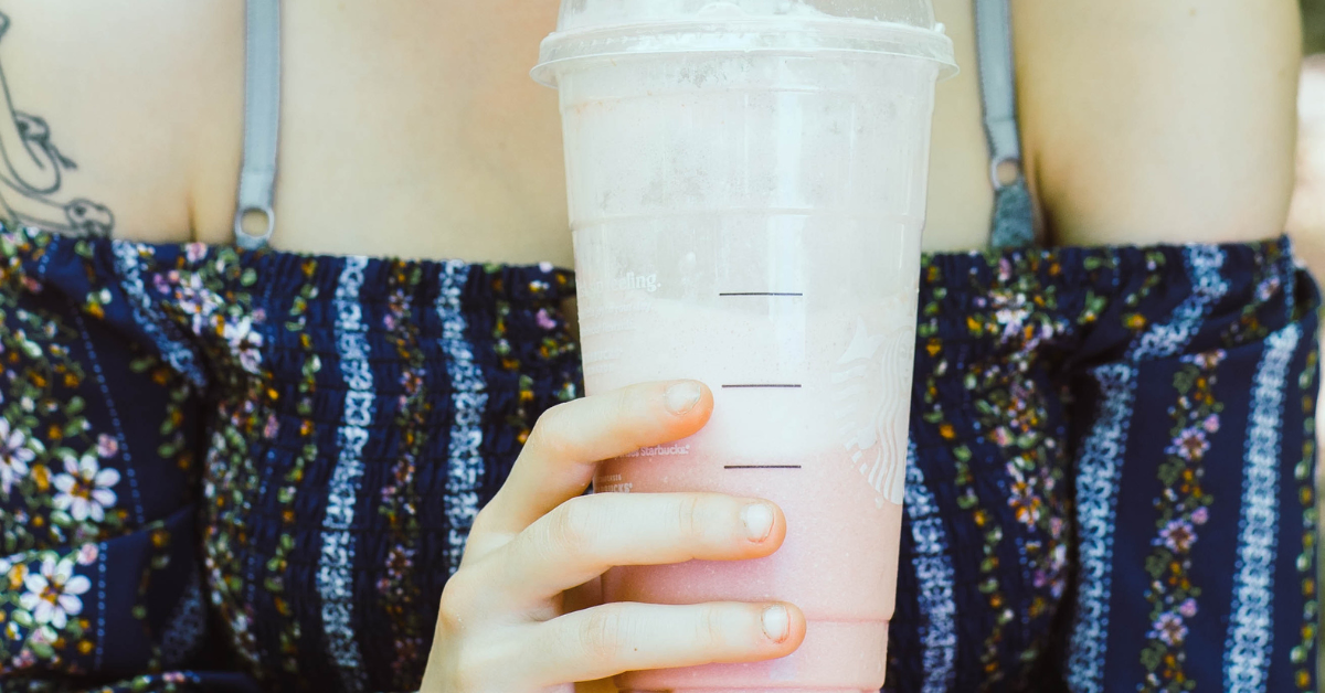 a girl drinking pink drink