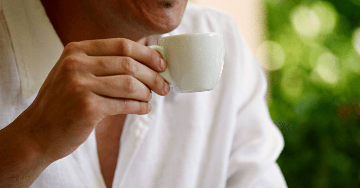 a man drinking espresso