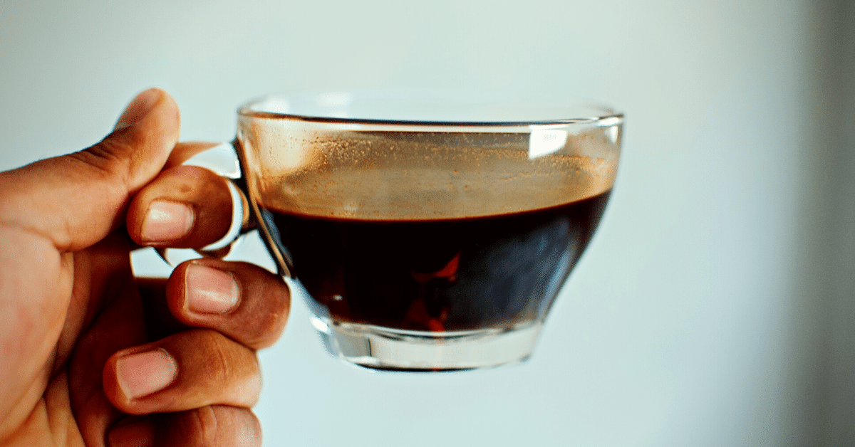 a person holding black coffee