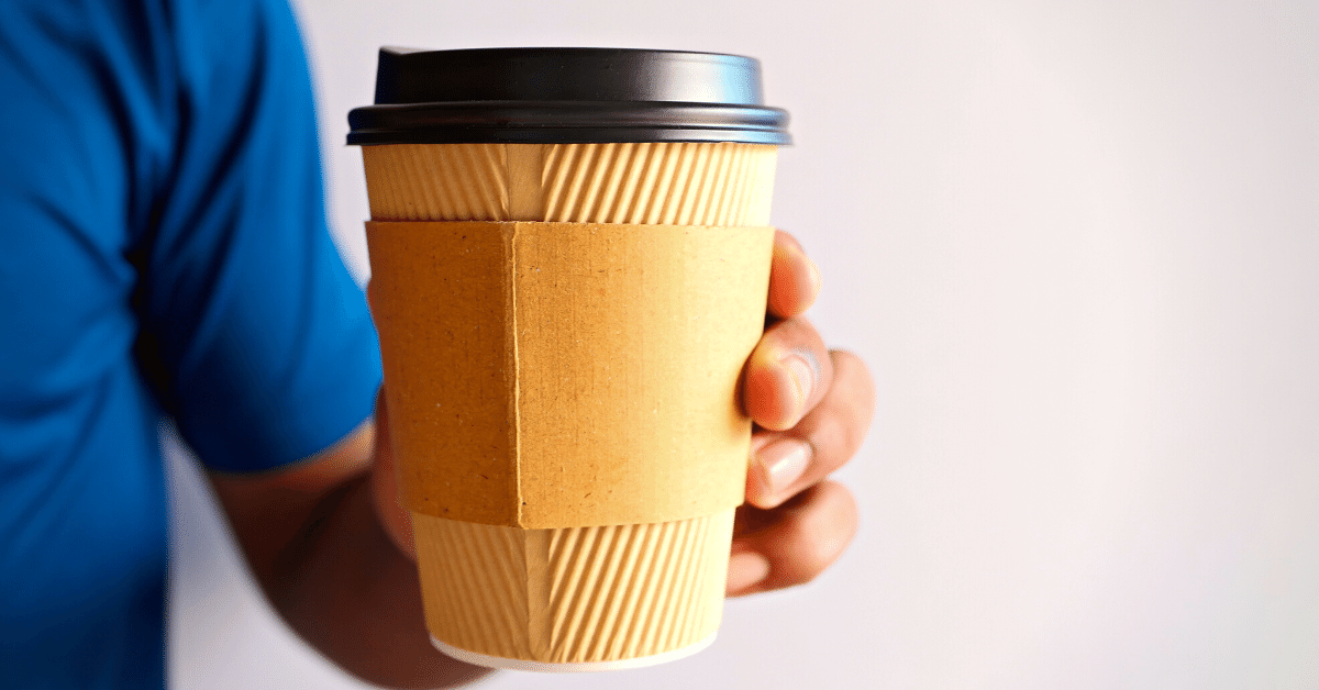 man holding cup of coffee