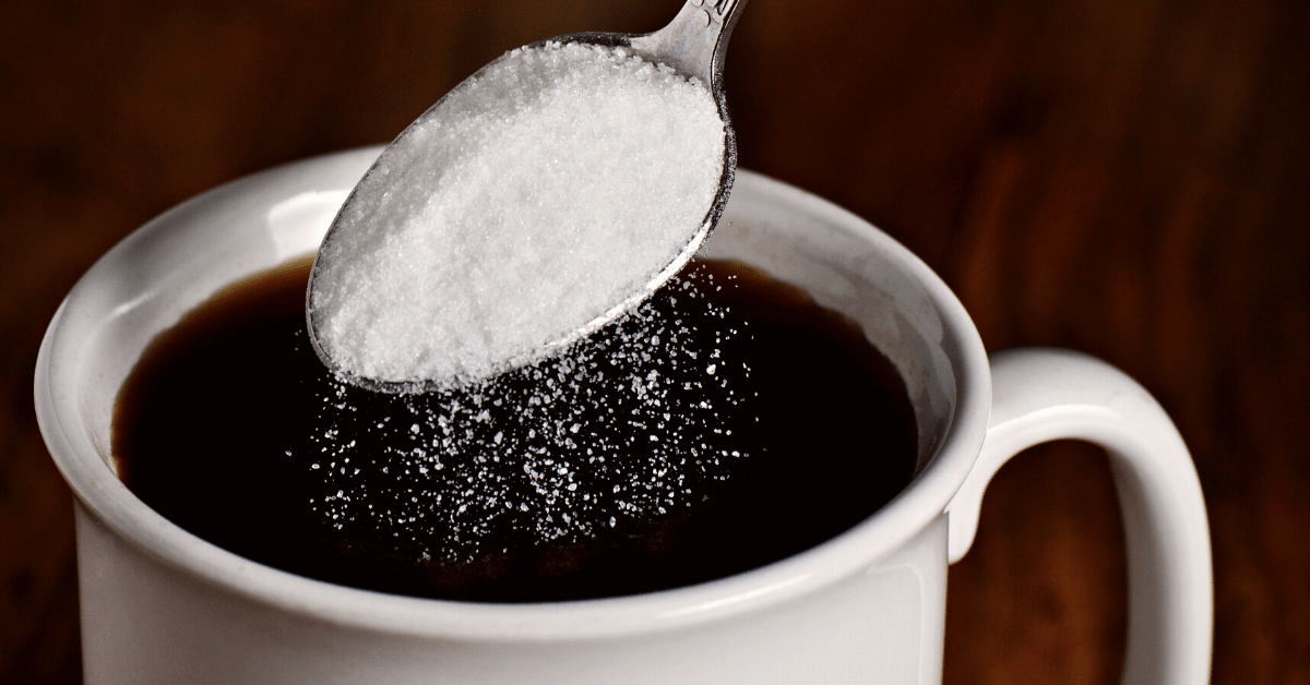 pouring sugar in coffee