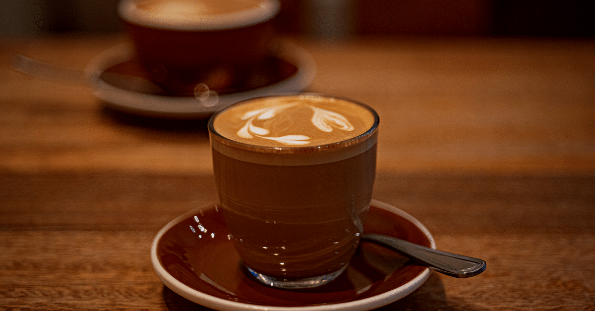 glass cup of cortado coffee