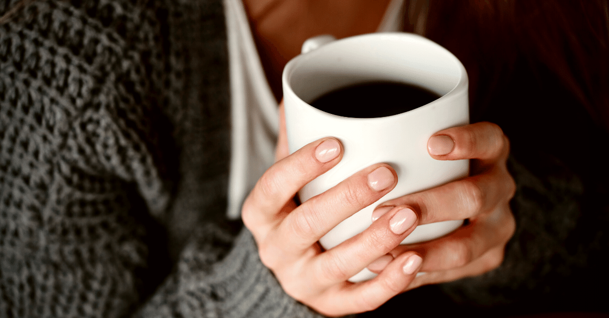 woman holding cup of coffee