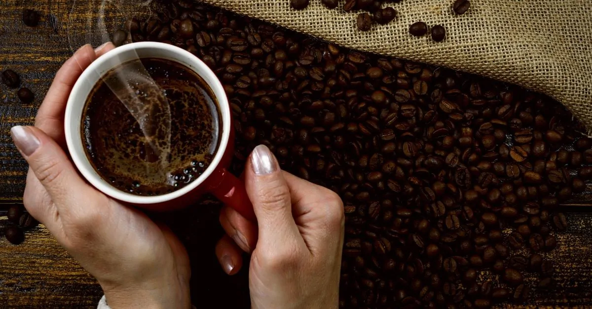 woman holding cup of coffee