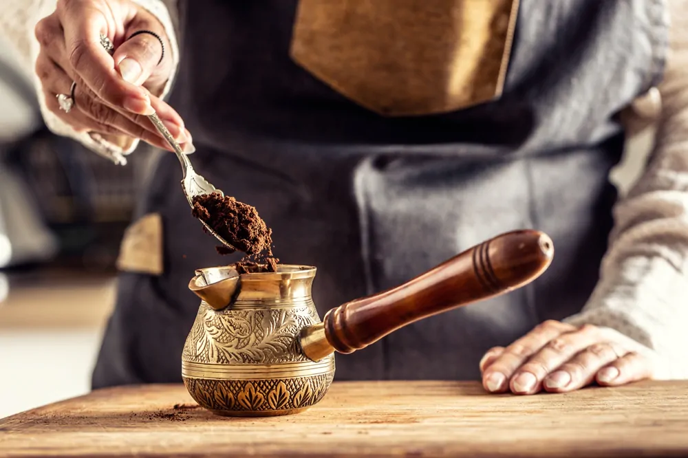  grounded coffee put into an ornamented cezve