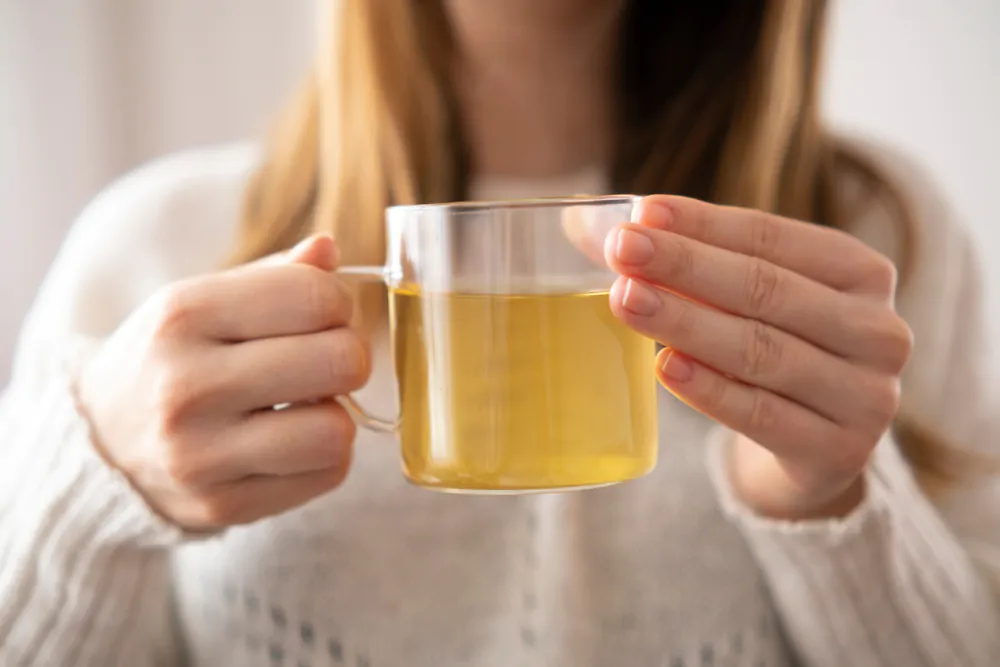  young woman drinking a cup of green tea